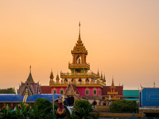 Fototapeta premium Sunset with Thai temple in Sisaket province,Thailand.