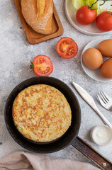 Tortilla Spanish omelette made with eggs and potatoes  on  served with traditional salad, mayonnaise  and bread. Spanish cuisine background.