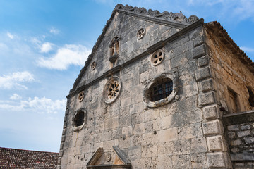 Street and front view of the detailed stone facade of the late Baroque church of St. Cyprian and Justin in town of Vis, Vis island Croatia..