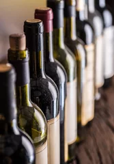 Fotobehang Line of wine bottles. Close-up. © volff