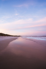 Epic pink and purple sunset over Cosy Corner Beach in Albany, Western Australia. Beautiful vibrant...