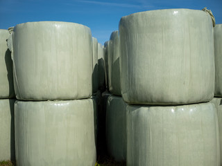 Runballs, hay bales wrapped in foil and stacked on top of each other for storage