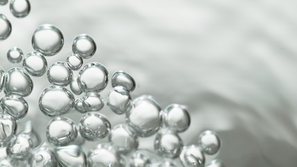 transparent gas bubbles on water surface. Worms-eye low angle with crystal bubbles in purified water on white background. cosmetic backdrop with copy space