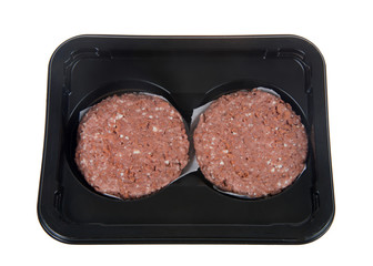 package of vegetable based burger patties, isolated on white. The first plant-based burger to be sold in the grocery store meat section.