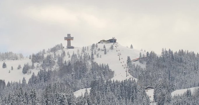 Austrian Ski resort St.Jakob in Haus wit mountain railway in the winter and jakobs cross in the background