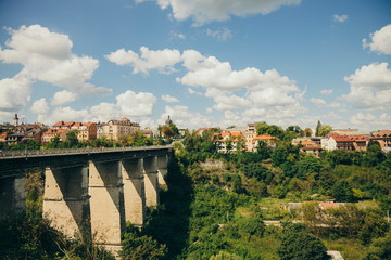 small European city landmark photography of stone bridge across canyon to old town touristic destination district in Ukraine 