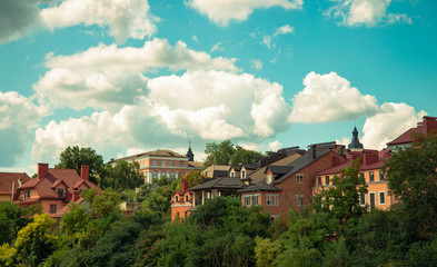 Ukraine small and cozy old city beautiful landmark view of colorful houses and green trees foliage with blue sky white clouds background 