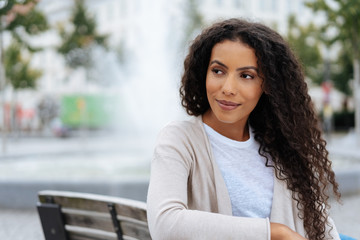 Thoughtful young woman looking behind her