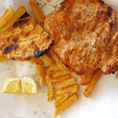 grilled chicken breast and french fries top view close up