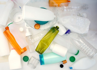Plastic bottles for recycling. crumpled  plastic bottles and containers heap. close up. separation concept. top view.