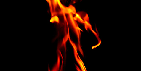 Fototapeta premium Fire texture isolated on black background. Fire flames on black background. Fire patterns. Texture of flames throughout the space. Red flames up close. The background with flames of fire..
