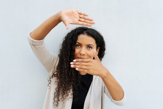 Young woman making a frame gesture with her hands