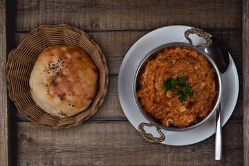 Turkish meze, acili ezme or spicy paste isolated on rustic wooden background