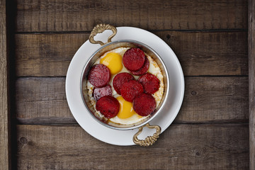 Turkish Sausage (sucuk) and egg isolated on rustic wooden table