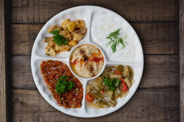 Mix plate arabic food with vegetarian spread starters isolated on rustic wooden background