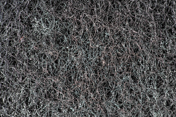 Dark abstract background and pattern of interwoven hairs, fibers and nanofibers. Sponge detail texture, sponge texture closeup background. Cellulose sponge texture. Black and white