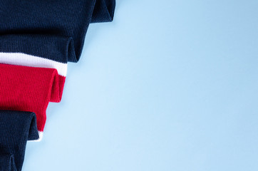 Striped cotton scarf composition on blue background.