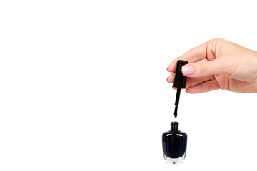 Hand with black nail polish bottle, beauty and care.