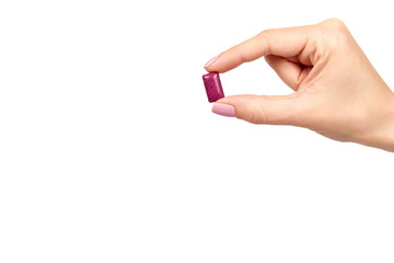 Hand with bright chewing gum, dental bubblegum.