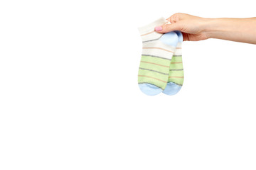 Hand with striped cotton sock, child footwear.