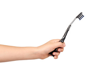Children hand with black toothbrush, kids tooth care, hygiene and freshness for mouth.