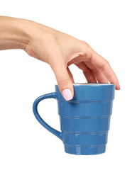 Hand with blue ceramic cup, mug for coffee and tea, kitchen pottery.