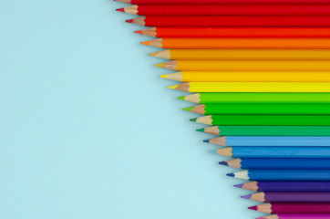 Colored pencils composition on blue background. Flat lay.