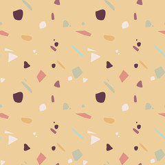 Seamless terrazzo pattern in autumnal colors on mustard background. Stone texture. Vector illustration, flat design
