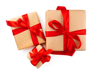 Craft christmas gifts with red bows isolated on white background, top view