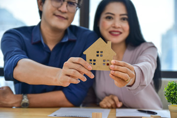 Close up home model couple are buying home for family