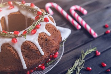 Homemade chocolate Christmas cake decorated with rosemary and pomegranate, front view