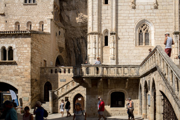 Naklejka premium Stone walls of historic Basilica of St-Sauveur blend into the cliff in Rocamadour, France
