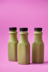 Green tea in bottle on white marble background.