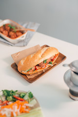 Banh Mi Xiu Mai is a popular pork ball sandwich with tomato sauce in Vietnam