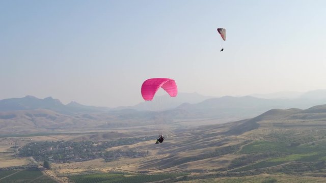 beautiful landscape with mountains and flying paragliders