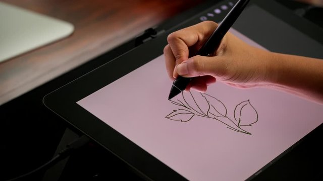 Woman graphic designer working with interactive pen display. Digital Drawing tablet and creative pen display, Digital arts design process.