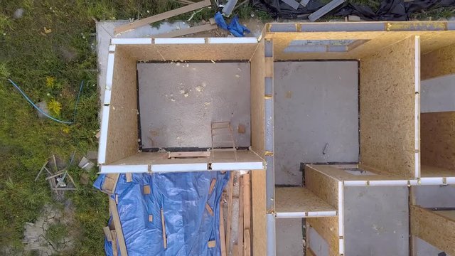 Construction of new and modern modular house. Walls made from composite wooden sip panels with styrofoam insulation inside. Building new frame of energy efficient home concept.