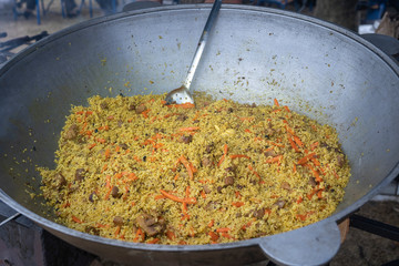 Pilaf in cauldron for sell in street food market, Ukraine, closeup