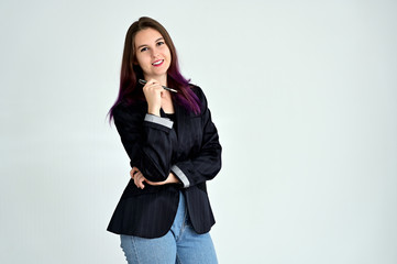 Studio portrait of a pretty brunette student girl with long hair in a jacket on a white background. Smiling at camera with emotions in various poses.