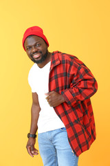 Portrait of happy African-American man on color background