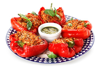 Plate with tasty stuffed pepper and sauce on white background