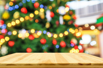 Empty wood table top with Abstract blur Christmas tree with decoration bokeh light background for product display