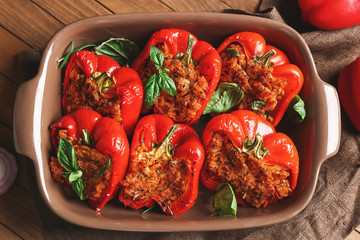 Baking dish with tasty stuffed pepper on table