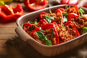 Baking dish with tasty stuffed pepper on table