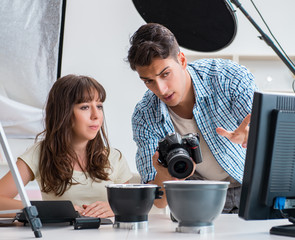 Young photographer working in photo studio