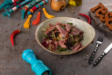 Salad wuth thinly sliced rare beef starter