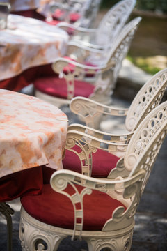 White metal chairs at a restaurant terrace