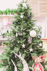 Christmas tree and decorations with abstract sparkling lights.White ball,stars in tones.toned.