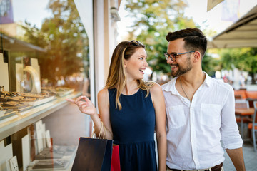 Consumerism, love, dating, travel concept. Couple enjoying shopping having fun