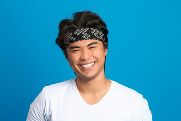 Portrait of handsome Asian man on color background